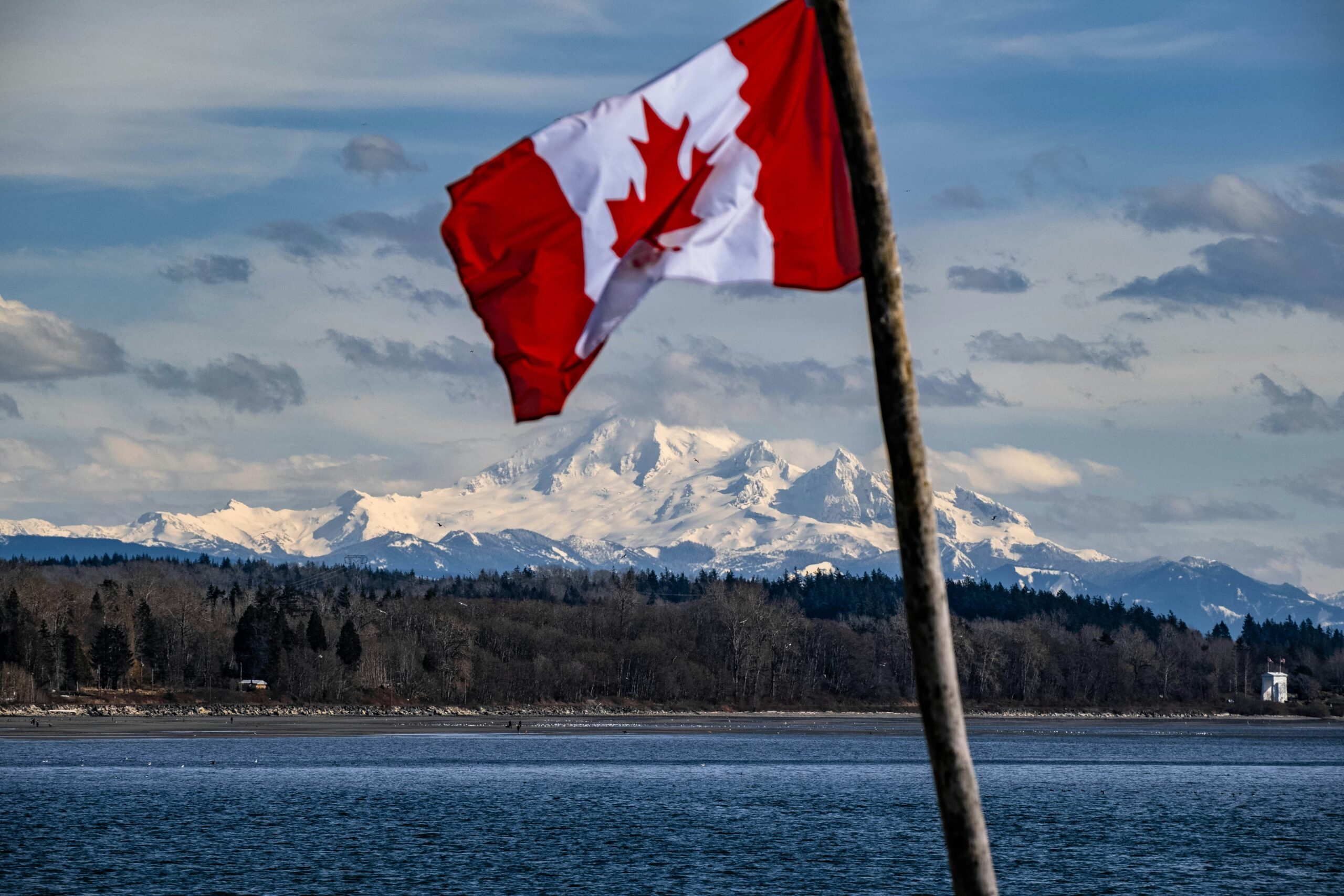canadian flag with a mountain in the background